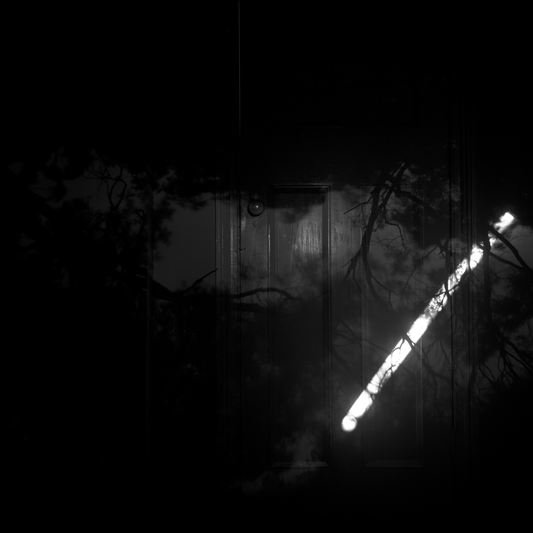 Dark, eerie scene with a glowing object in the foreground