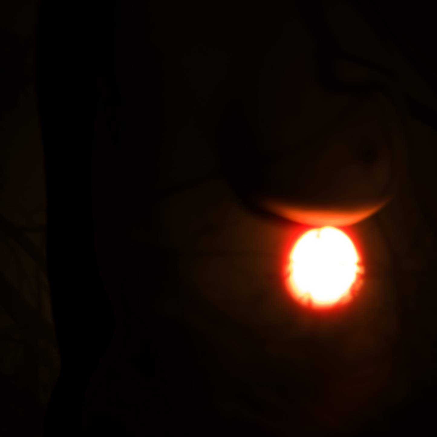 Bright red light source in a dark setting